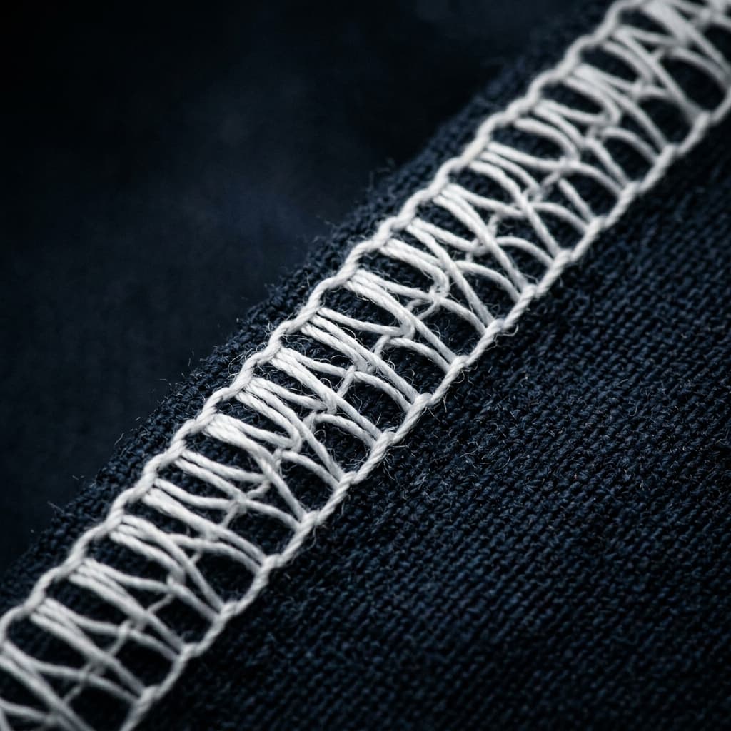 Close-up of precision stitching on a tracksuit — RayoRise manufacturing detail